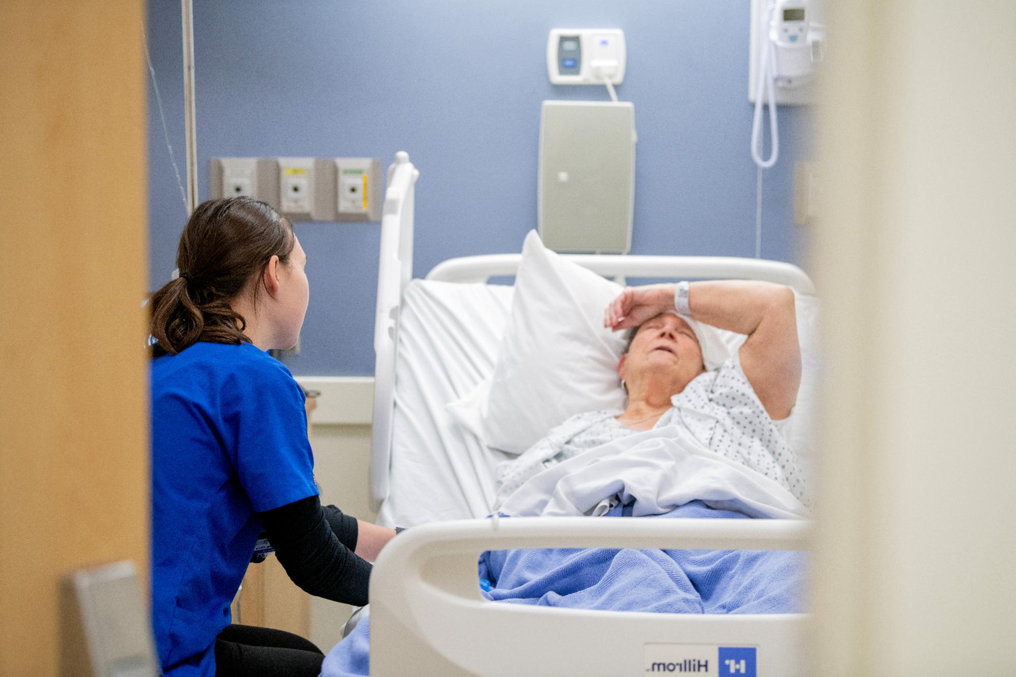 students in blue scrubs observes patient